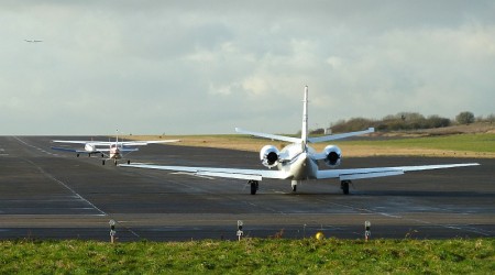 The last three aircraft to take-off from the airfield line up on the runway.