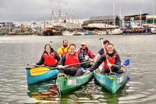 Photo of Village Hotel Club Bristol employees on the water with Young Bristol leaders near Pooles Wharf.